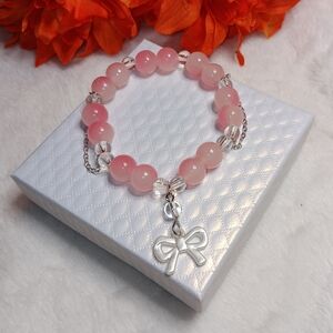 Elegant Pink Beaded Bracelet with Bow Charm